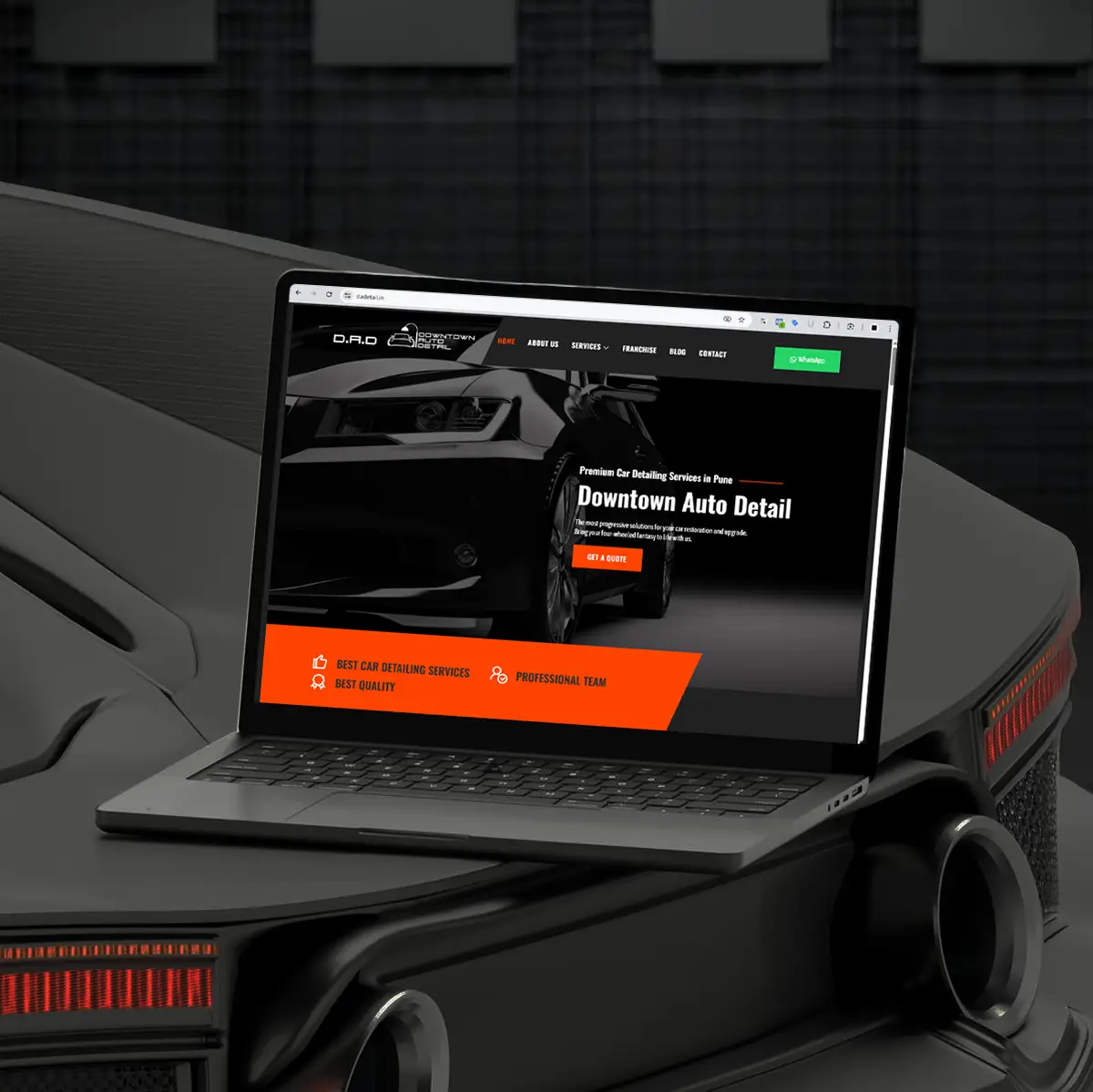 Laptop displaying the Downtown Auto Detail website, a car detailing service in Pune, designed by Thinkster — featuring a sleek black and orange interface with bold typography and a premium automotive aesthetic.