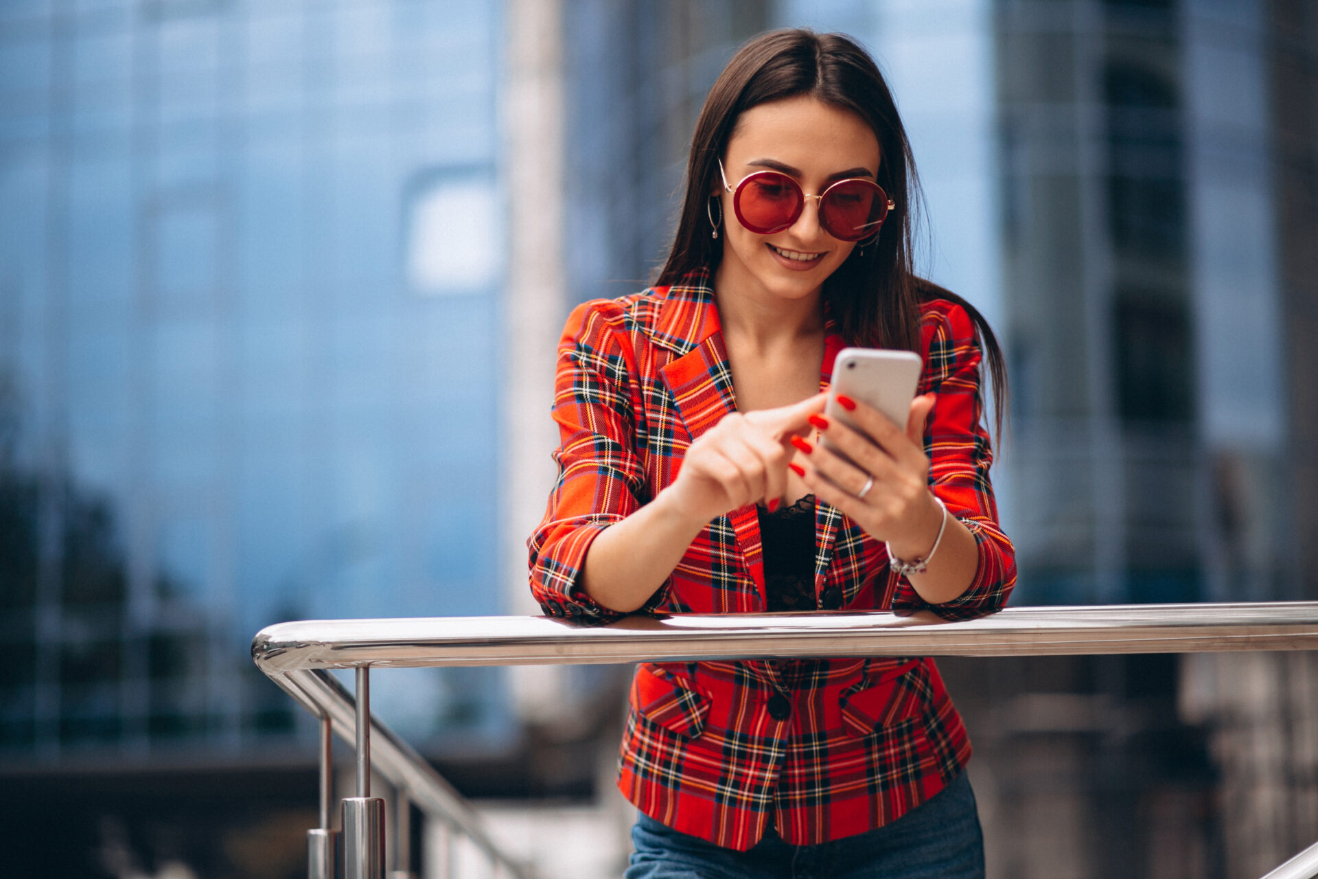 young-woman-talking-phone-by-office-center.jpg